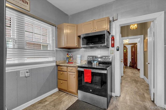 2505 Chicago Blvd, Detroit, MI 48206 - kitchen featuring appliances with stainless steel finishes, light brown cabinetry, a chandelier, light tile patterned floors, and baseboards