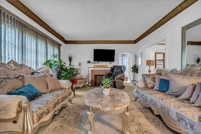 2505 Chicago Blvd, Detroit, MI 48206 - living room featuring carpet, plenty of natural light, a textured ceiling, crown molding, and a tile fireplace