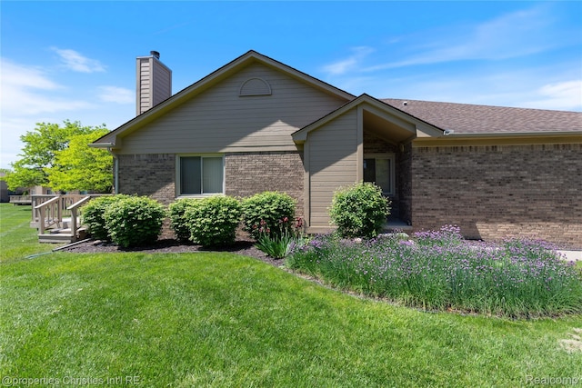 15380 Windmill Cir, Macomb, MI 48044 - view of side of home with brick siding, a lawn, and a chimney