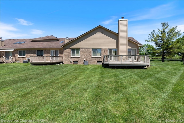 15380 Windmill Cir, Macomb, MI 48044 - rear view of house with a chimney, a deck, and a yard