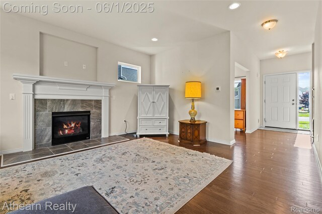 305 Beaver Run, Holly, MI 48442 - living area featuring dark wood finished floors, a tile fireplace, recessed lighting, and baseboards