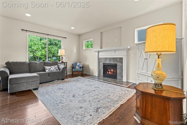 305 Beaver Run, Holly, MI 48442 - living room with dark wood-style flooring, healthy amount of natural light, a tile fireplace, and recessed lighting
