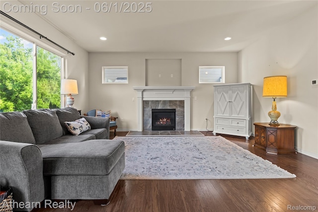 305 Beaver Run, Holly, MI 48442 - living area featuring a tiled fireplace, dark wood-type flooring, baseboards, and recessed lighting