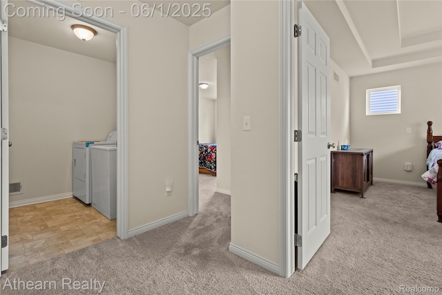 305 Beaver Run, Holly, MI 48442 - hallway featuring separate washer and dryer, light colored carpet, and baseboards