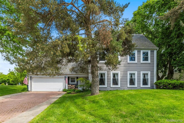 5138 Bayside Dr, Troy, MI 48098 - view of front of house with decorative driveway, a front lawn, a garage, and roof with shingles