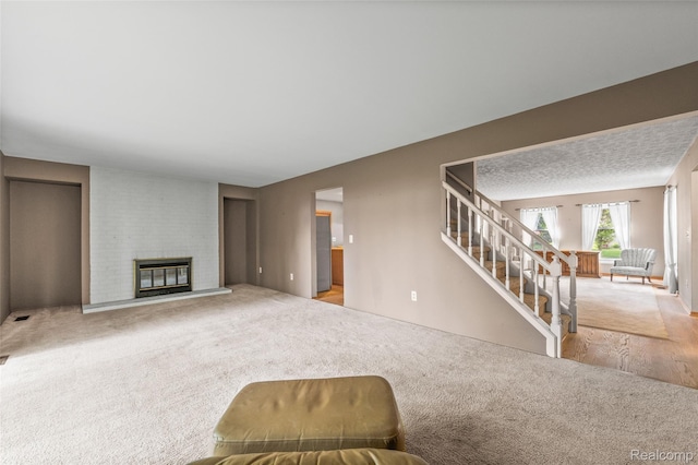 5138 Bayside Dr, Troy, MI 48098 - living area with carpet flooring, stairs, and a fireplace