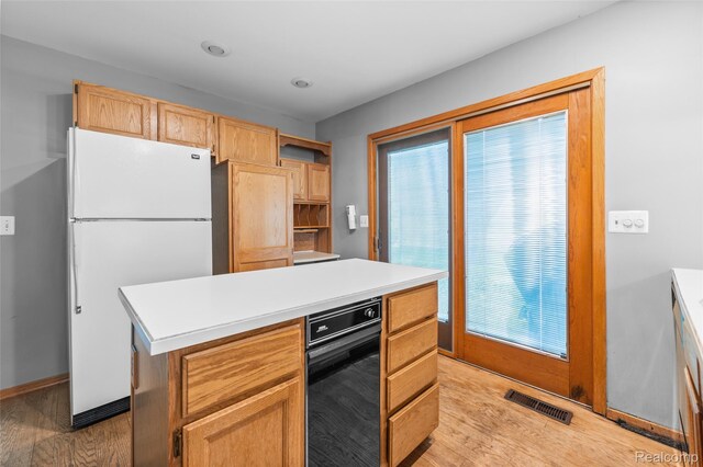 5138 Bayside Dr, Troy, MI 48098 - kitchen with freestanding refrigerator, light wood-type flooring, light countertops, a kitchen island, and baseboards