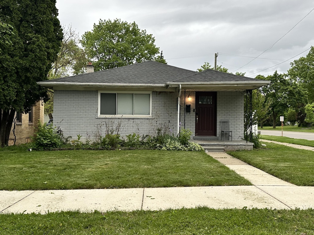 22400 W Chicago, Redford, MI 48239 - view of front facade featuring covered porch, brick siding, and a front lawn