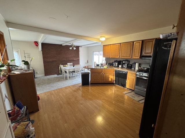 13497 Mark St, Southgate, MI 48195 - kitchen featuring black appliances, brown cabinets, open floor plan, beamed ceiling, and light wood finished floors