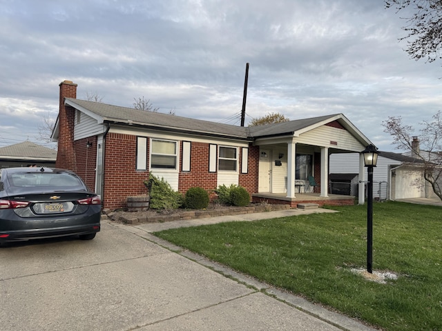 13497 Mark St, Southgate, MI 48195 - ranch-style house featuring brick siding, a porch, a chimney, a front yard, and a shingled roof
