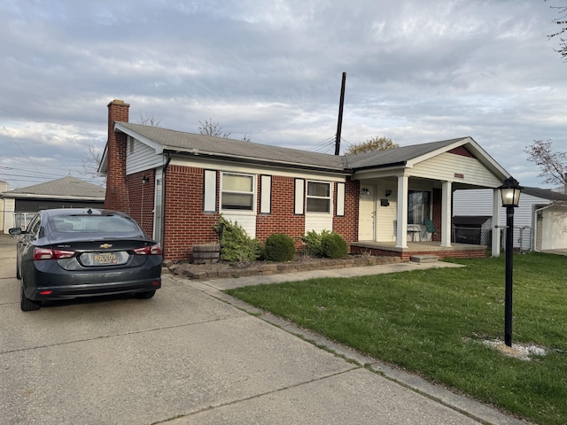 13497 Mark St, Southgate, MI 48195 - single story home with brick siding, a chimney, a front yard, a porch, and concrete driveway