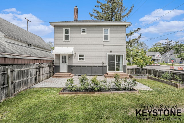 258 Ann St NE, Grand Rapids, MI 49505 - rear view of property with a garden, a chimney, and entry steps