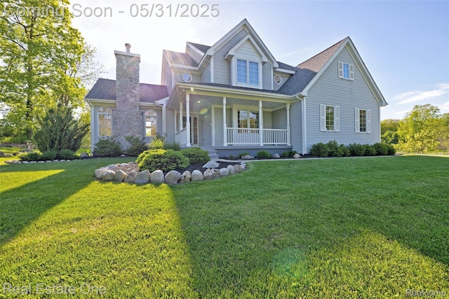 1572 S Hadley Rd, Ortonville, MI 48462 - view of front of house featuring a porch, a front yard, and a chimney