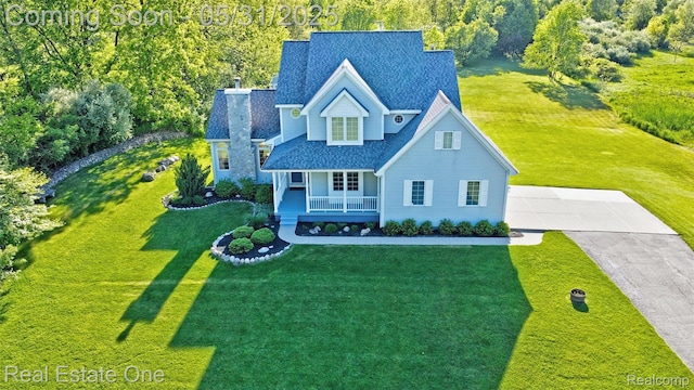 1572 S Hadley Rd, Ortonville, MI 48462 - traditional home featuring covered porch, a chimney, driveway, a front yard, and roof with shingles