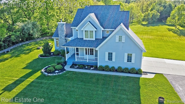 1572 S Hadley Rd, Ortonville, MI 48462 - traditional home featuring covered porch, a shingled roof, a front lawn, and driveway