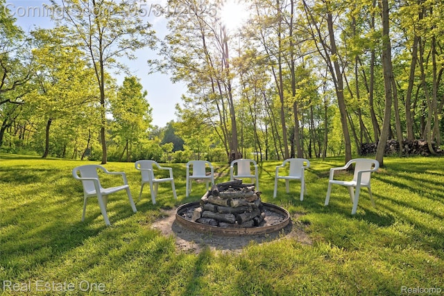 1572 S Hadley Rd, Ortonville, MI 48462 - view of green lawn with an outdoor fire pit