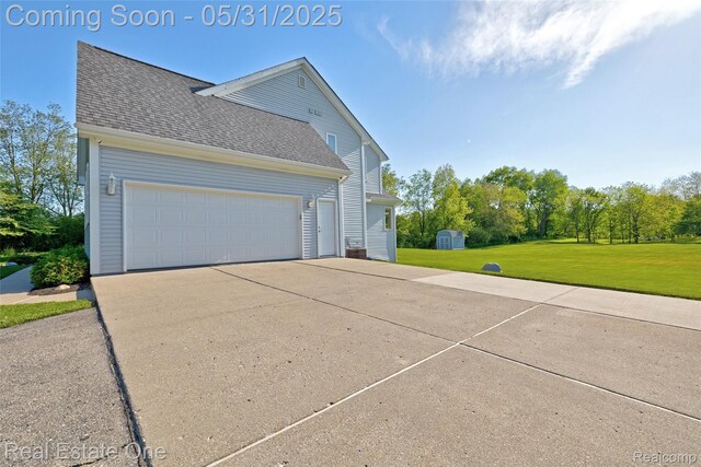1572 S Hadley Rd, Ortonville, MI 48462 - view of property exterior with a yard, a shingled roof, concrete driveway, and a garage