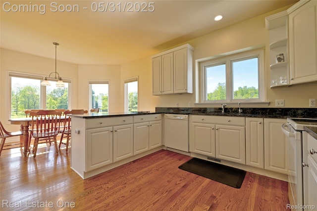 1572 S Hadley Rd, Ortonville, MI 48462 - kitchen with white appliances, a peninsula, a sink, open shelves, and white cabinetry