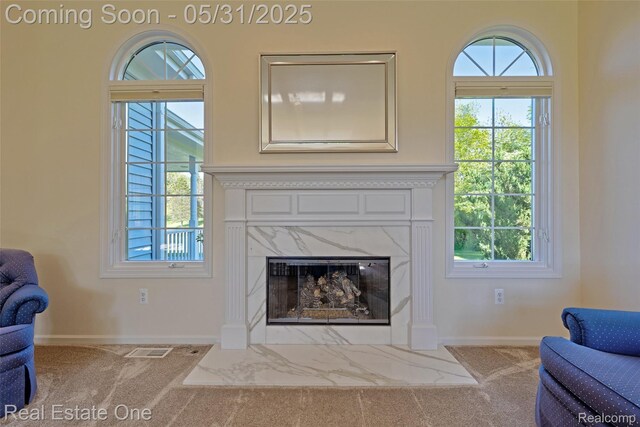 1572 S Hadley Rd, Ortonville, MI 48462 - living room with carpet flooring, a high end fireplace, and baseboards