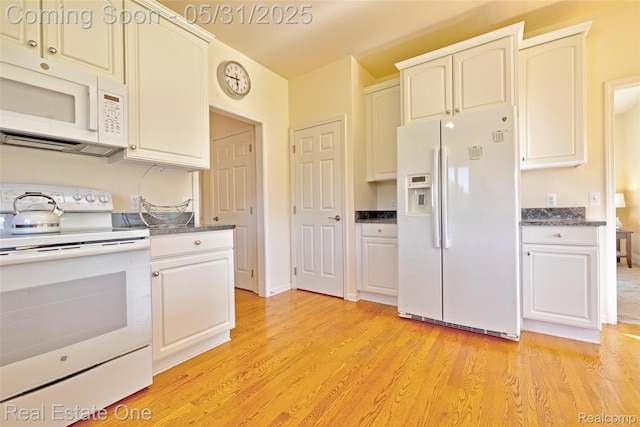 1572 S Hadley Rd, Ortonville, MI 48462 - kitchen with white appliances, light wood-type flooring, and dark countertops
