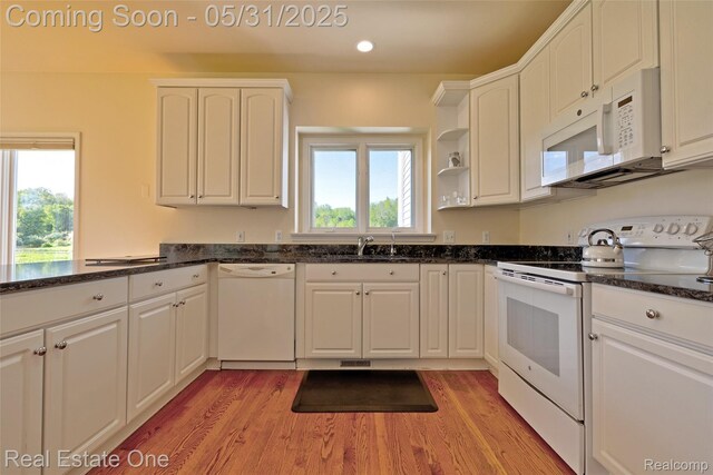 1572 S Hadley Rd, Ortonville, MI 48462 - kitchen featuring white appliances, a sink, light wood-type flooring, white cabinetry, and recessed lighting