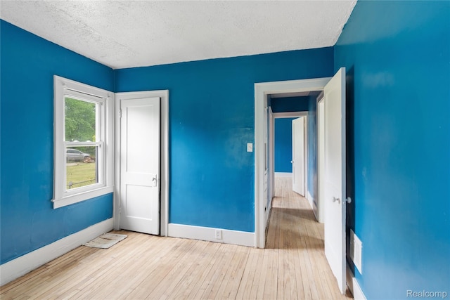 15730 Winthrop St, Detroit, MI 48227 - unfurnished bedroom featuring hardwood / wood-style floors, a textured ceiling, and baseboards