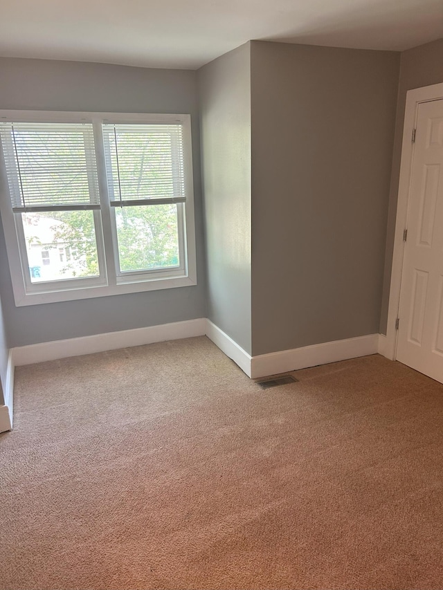 94 E Burnham St, Battle Creek, MI 49015 - spare room with light colored carpet and baseboards