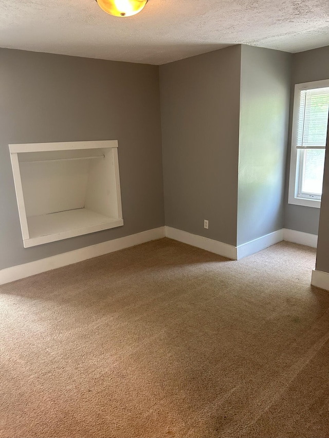 94 E Burnham St, Battle Creek, MI 49015 - carpeted empty room featuring a textured ceiling and baseboards