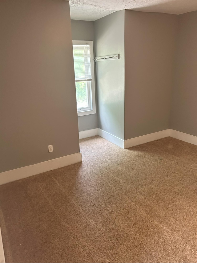 94 E Burnham St, Battle Creek, MI 49015 - carpeted empty room featuring baseboards and a textured ceiling