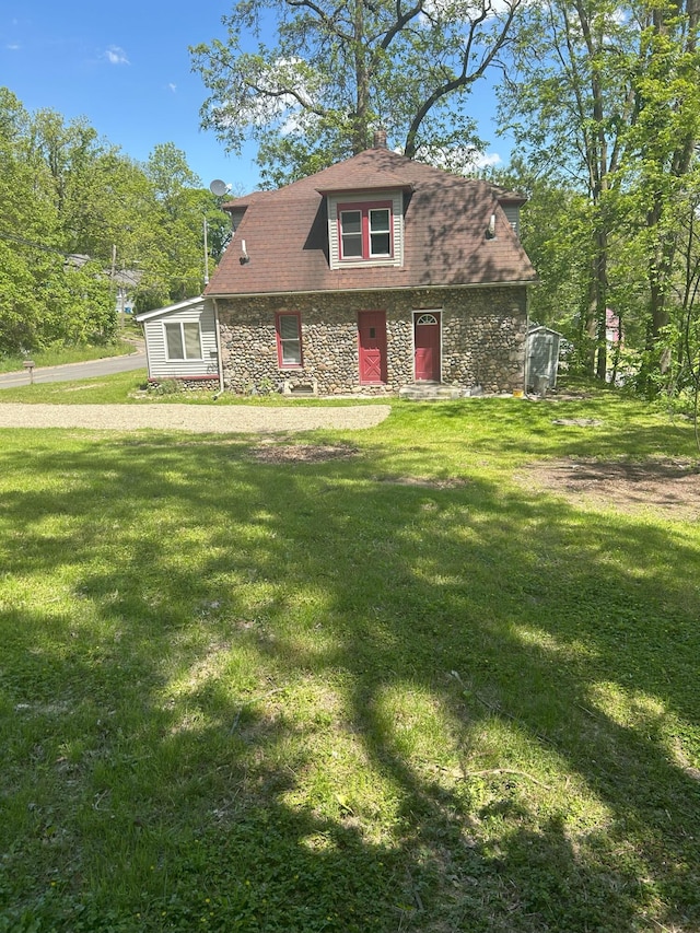 94 E Burnham St, Battle Creek, MI 49015 - view of front facade featuring stone siding and a front lawn