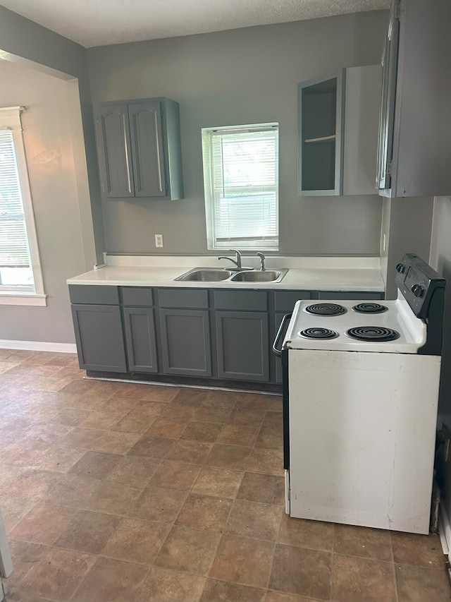 94 E Burnham St, Battle Creek, MI 49015 - kitchen with electric stove, a sink, gray cabinetry, and light countertops