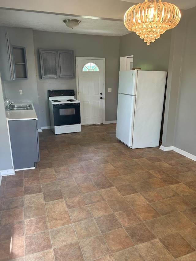 94 E Burnham St, Battle Creek, MI 49015 - kitchen with range with electric stovetop, freestanding refrigerator, a sink, and baseboards