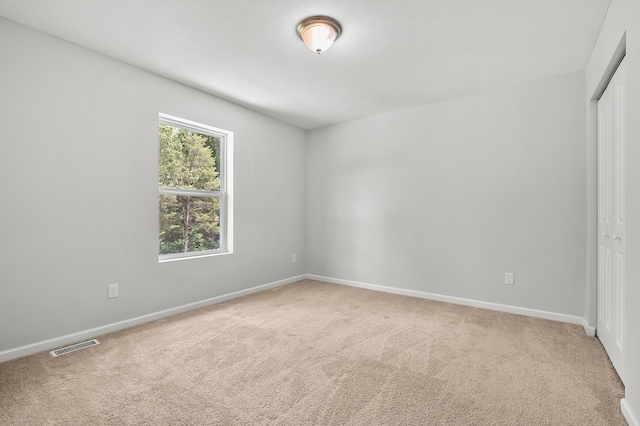 10126 Castle Creek Cir, Galesburg, MI 49053 - unfurnished bedroom featuring light colored carpet, a closet, and baseboards