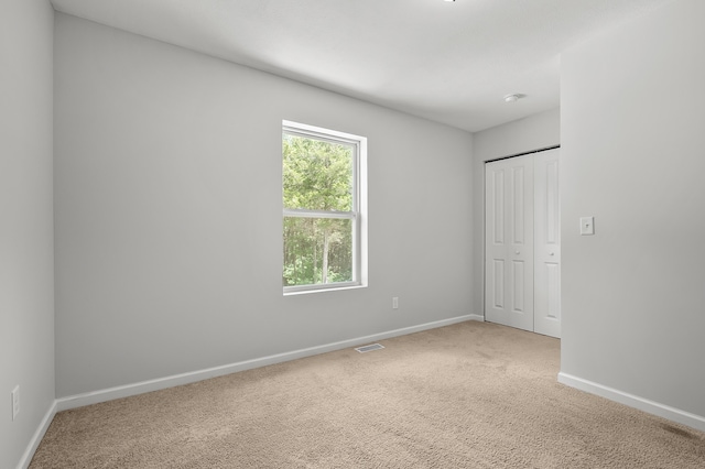 10126 Castle Creek Cir, Galesburg, MI 49053 - unfurnished bedroom featuring baseboards, carpet flooring, and a closet