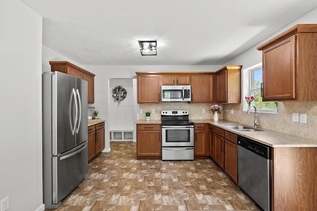 10126 Castle Creek Cir, Galesburg, MI 49053 - kitchen with stainless steel appliances, a sink, light countertops, and decorative backsplash