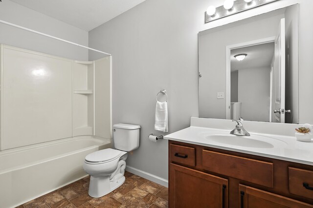 10126 Castle Creek Cir, Galesburg, MI 49053 - bathroom with vanity, shower / bathtub combination, toilet, stone finish flooring, and baseboards