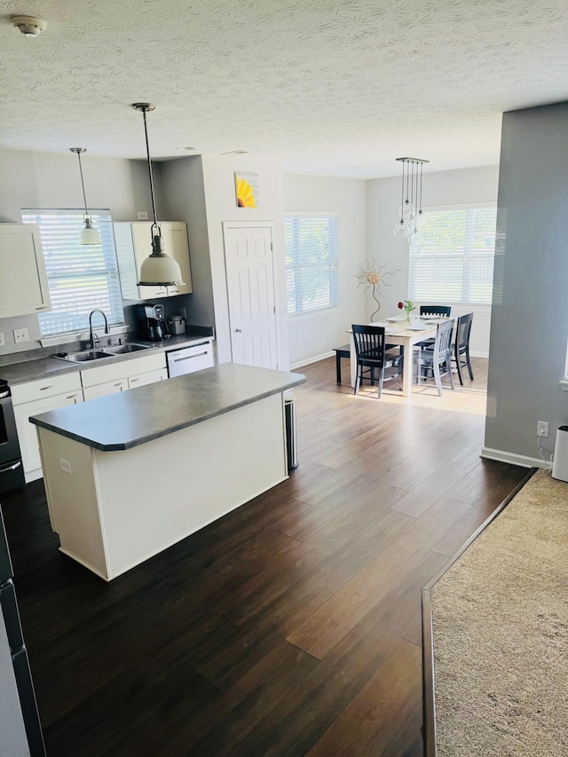8287 Falkirk Dr, Indiana, IN 46123 - kitchen featuring a sink, dark wood-type flooring, white cabinets, dark countertops, and a textured ceiling