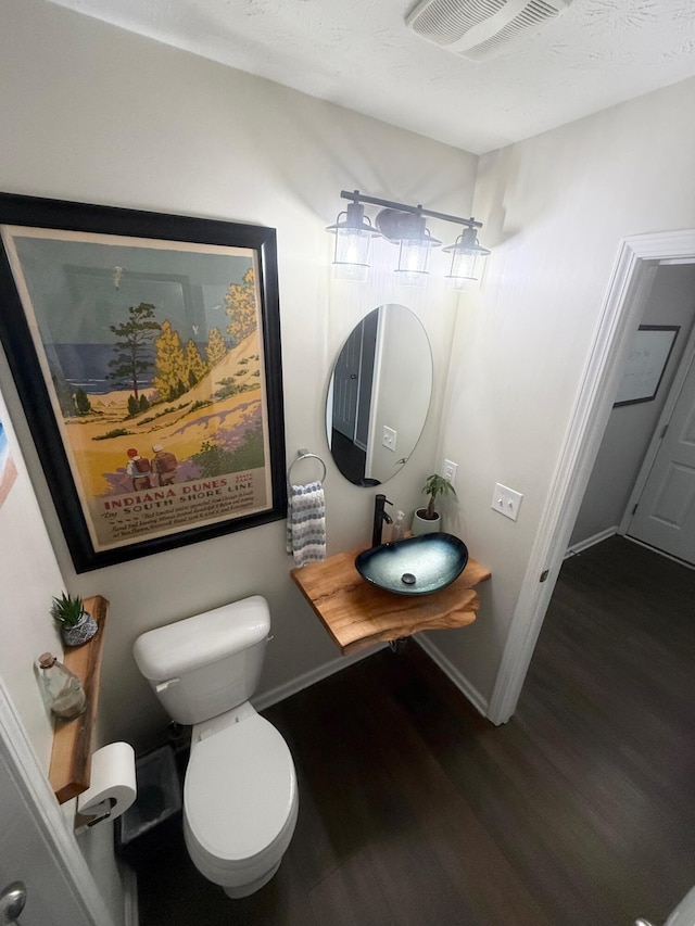 8287 Falkirk Dr, Indiana, IN 46123 - bathroom featuring a sink, wood finished floors, toilet, and baseboards