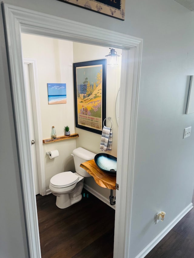 8287 Falkirk Dr, Indiana, IN 46123 - bathroom featuring wood finished floors, toilet, and baseboards