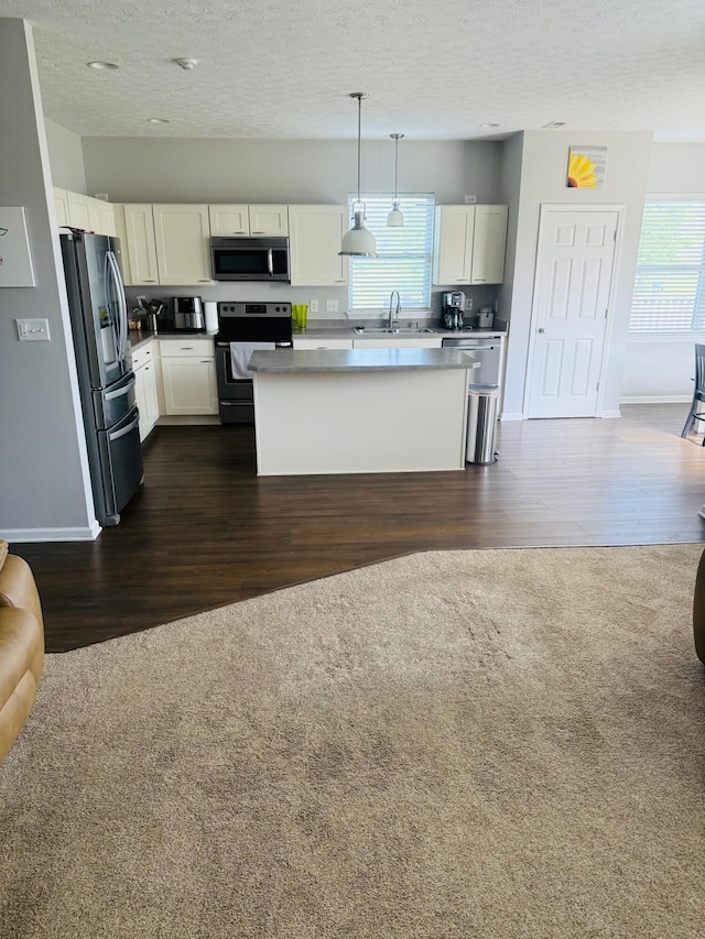 8287 Falkirk Dr, Indiana, IN 46123 - kitchen featuring stainless steel appliances, a sink, dark wood finished floors, open floor plan, and white cabinets