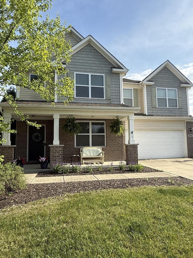 8287 Falkirk Dr, Indiana, IN 46123 - craftsman-style house with covered porch, an attached garage, concrete driveway, brick siding, and a front yard