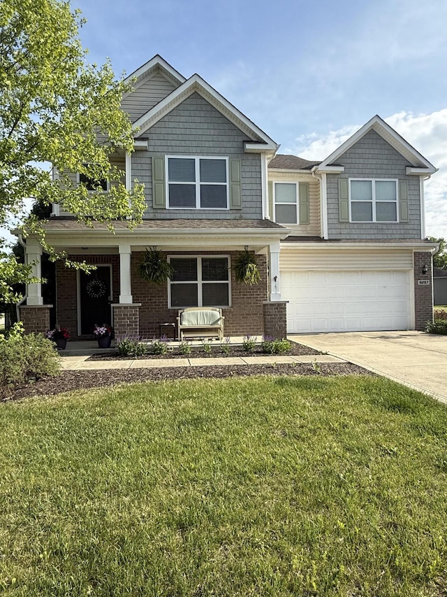 8287 Falkirk Dr, Indiana, IN 46123 - craftsman-style home with an attached garage, concrete driveway, a front lawn, a porch, and brick siding