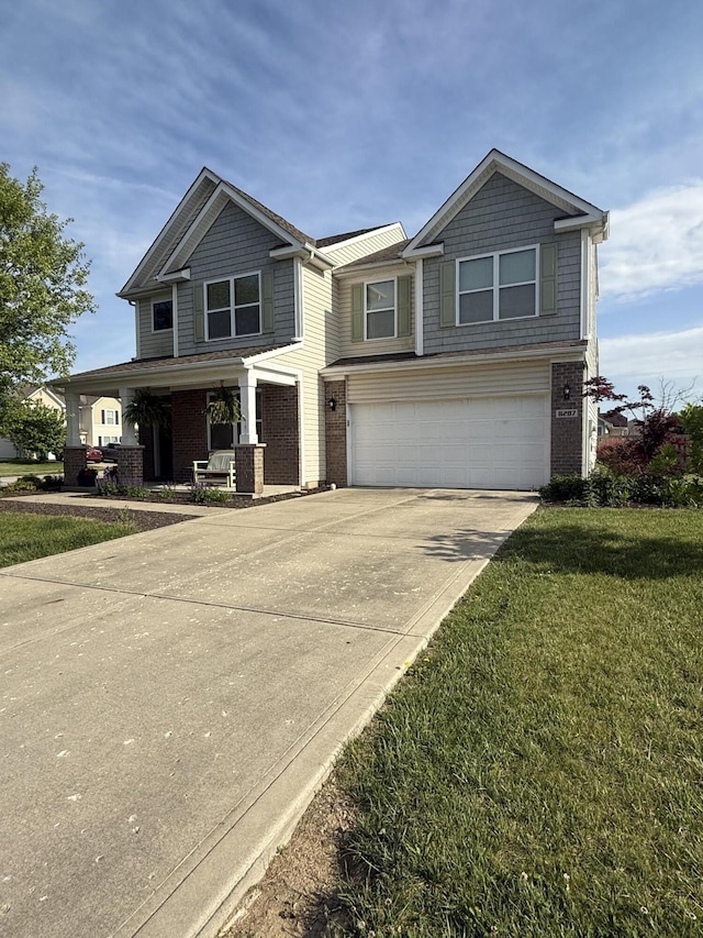 8287 Falkirk Dr, Indiana, IN 46123 - view of front of house with an attached garage, driveway, brick siding, and a front yard
