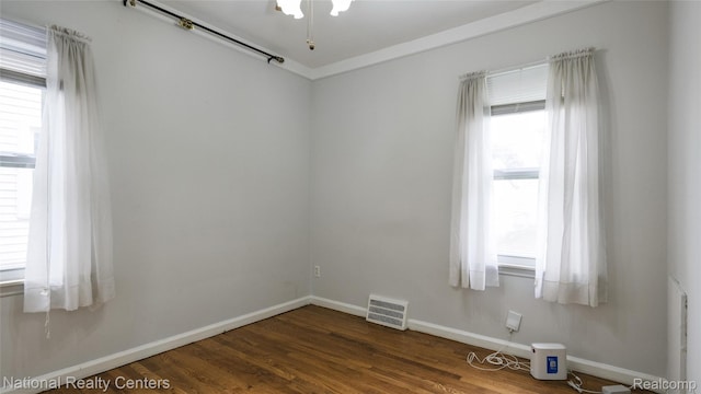 3446 17th St, Wyandotte, MI 48192 - spare room with baseboards and dark wood-style flooring