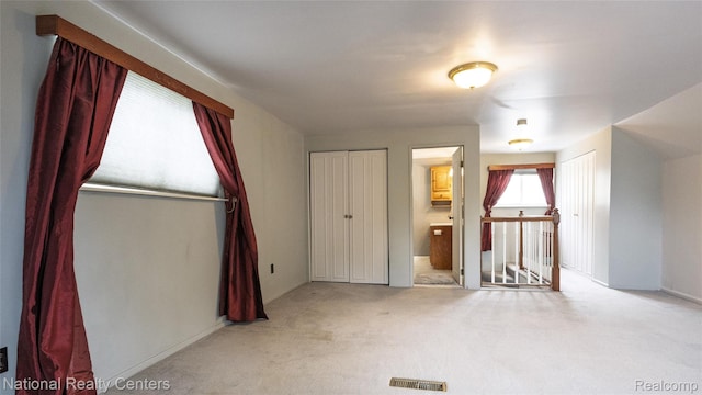 3446 17th St, Wyandotte, MI 48192 - unfurnished bedroom featuring multiple closets and light carpet