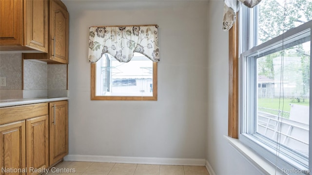 3446 17th St, Wyandotte, MI 48192 - kitchen featuring healthy amount of natural light, brown cabinetry, and baseboards