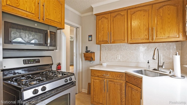 3446 17th St, Wyandotte, MI 48192 - kitchen with appliances with stainless steel finishes, a sink, brown cabinets, backsplash, and light countertops