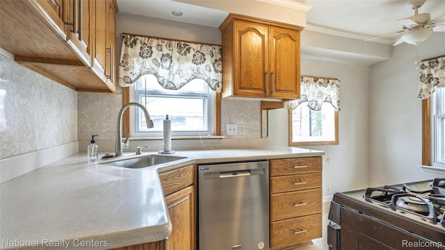 3446 17th St, Wyandotte, MI 48192 - kitchen featuring stainless steel dishwasher, a sink, brown cabinetry, range with gas stovetop, and a ceiling fan