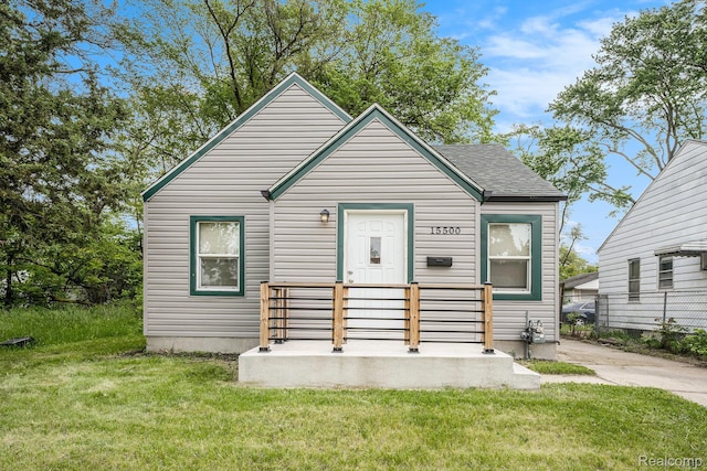 15500 Strathmoor St, Detroit, MI 48227 - bungalow featuring a front yard and a shingled roof