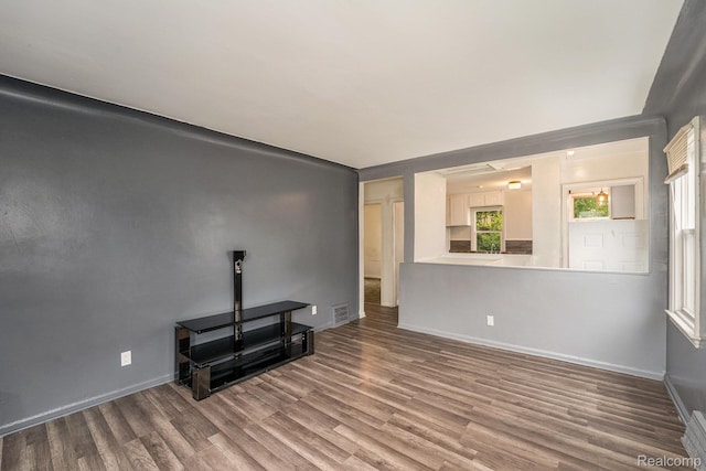 15500 Strathmoor St, Detroit, MI 48227 - unfurnished living room with wood finished floors and baseboards